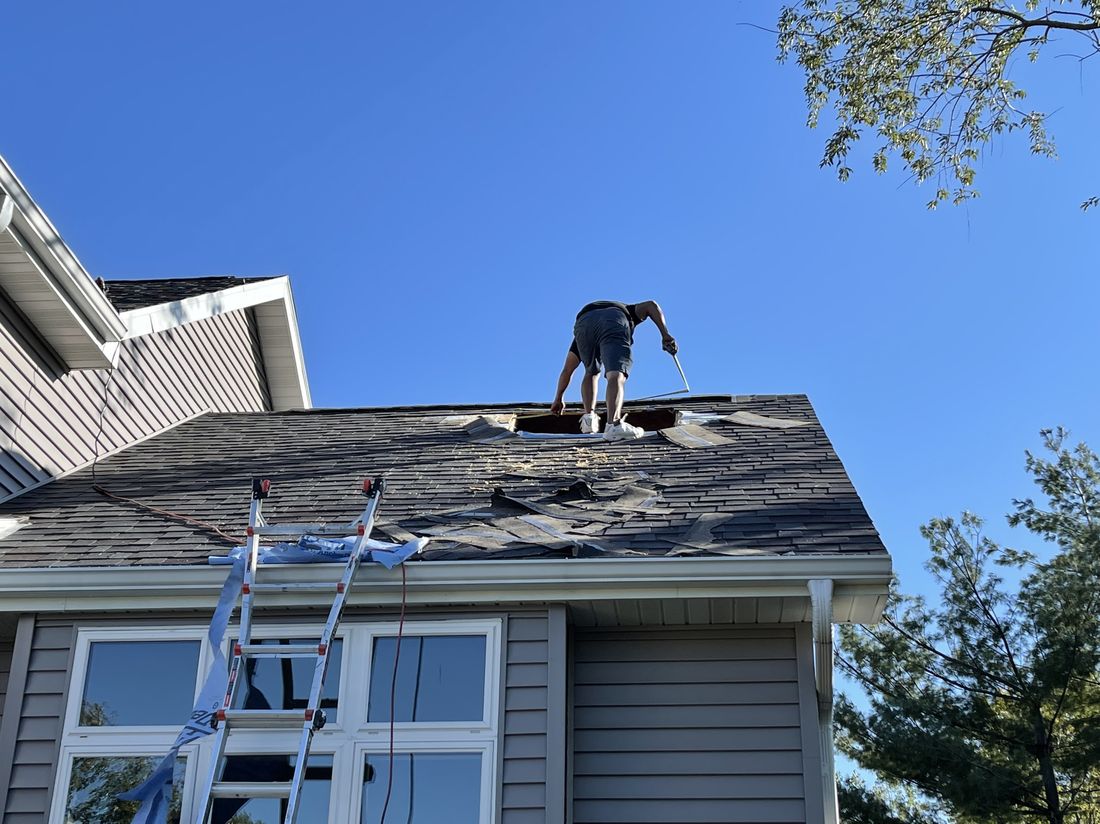 Trego Roofing crew member at work after storm damage