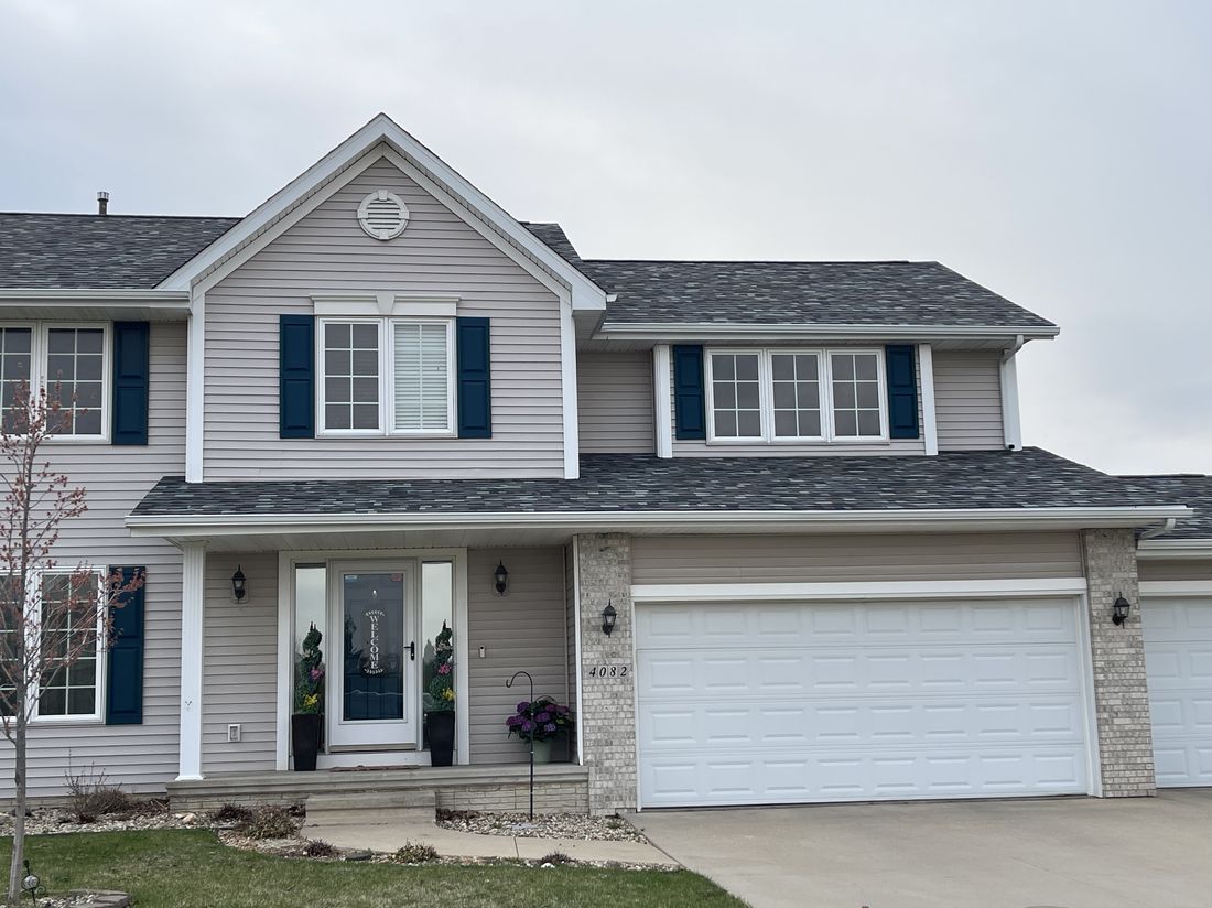 Completed two-story home with a new asphalt shingle roof by Trego Roofing