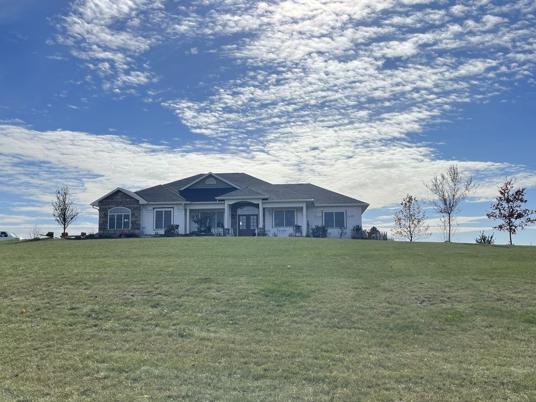 Completed ranch-style home with a new roof by Trego Roofing