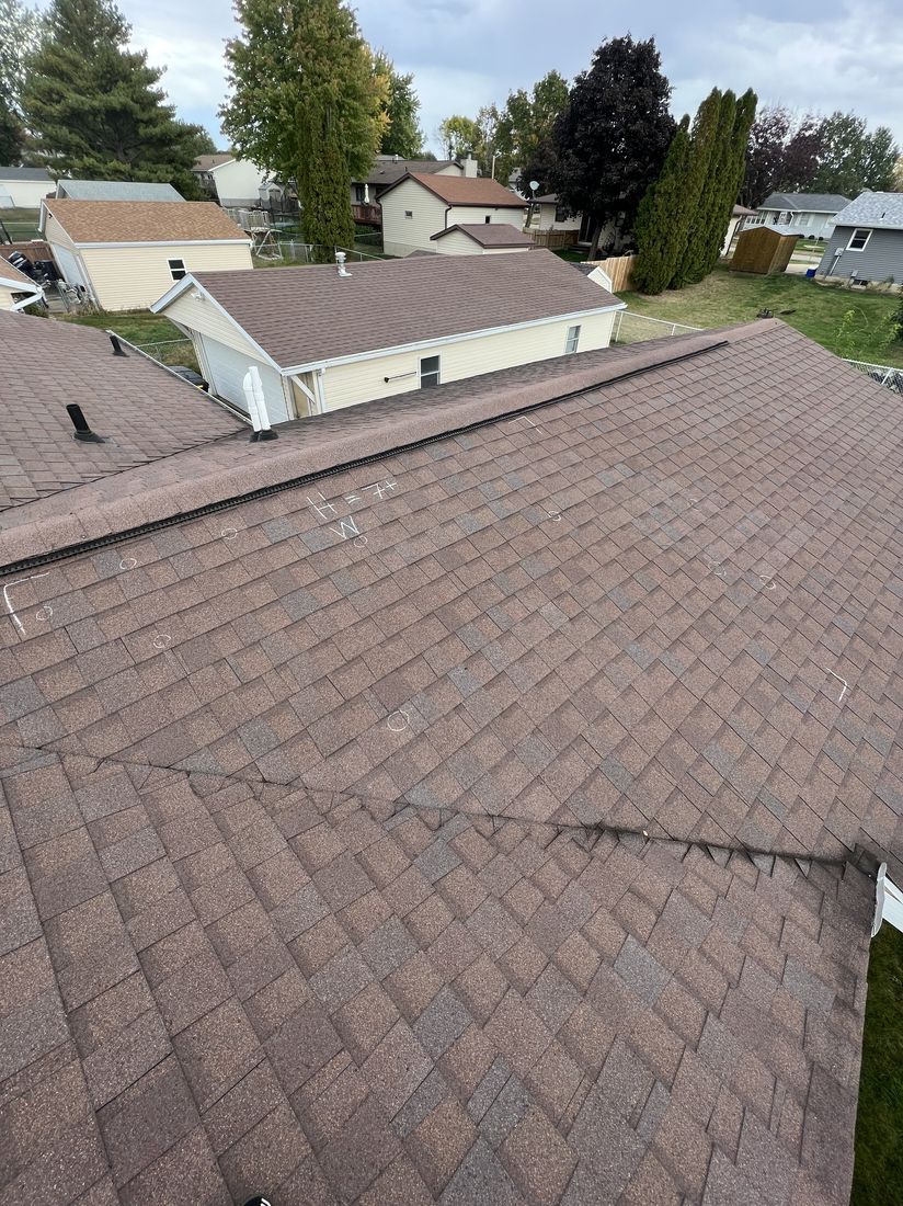 Aerial angle of a shingle roof over a neighborhood