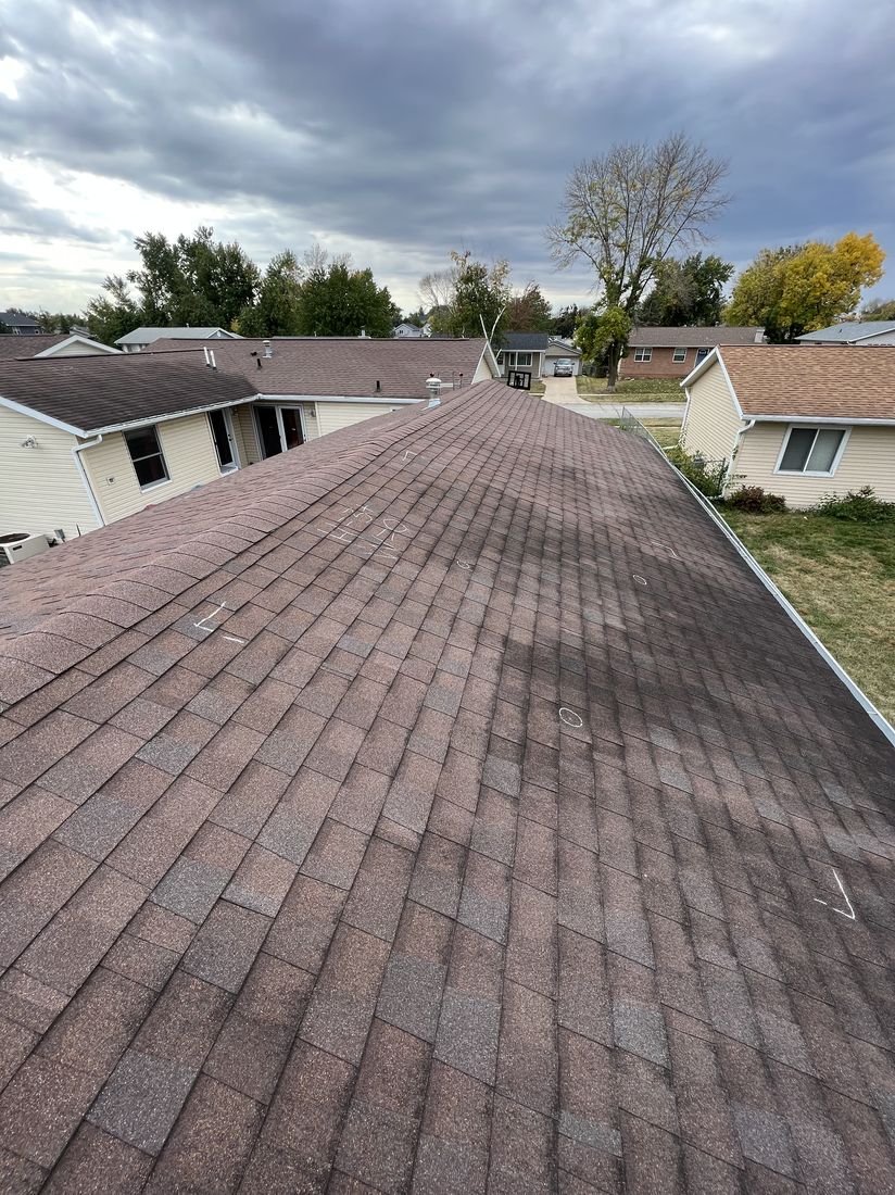 Aerial angle of a shingle roof over a neighborhood street