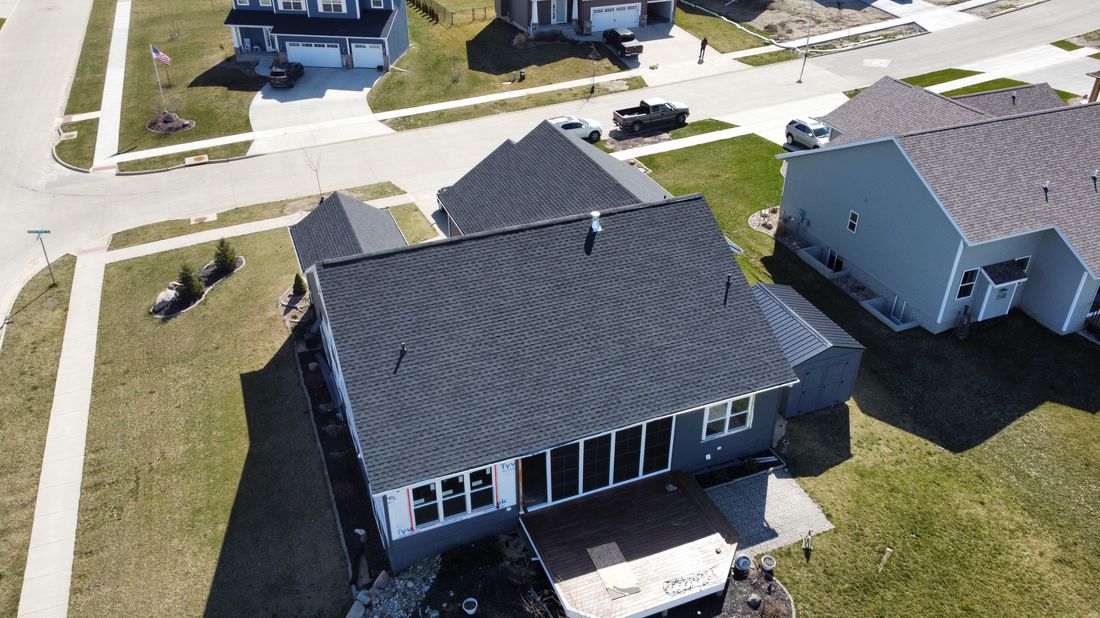 Aerial view of a completed gray shingle roof
