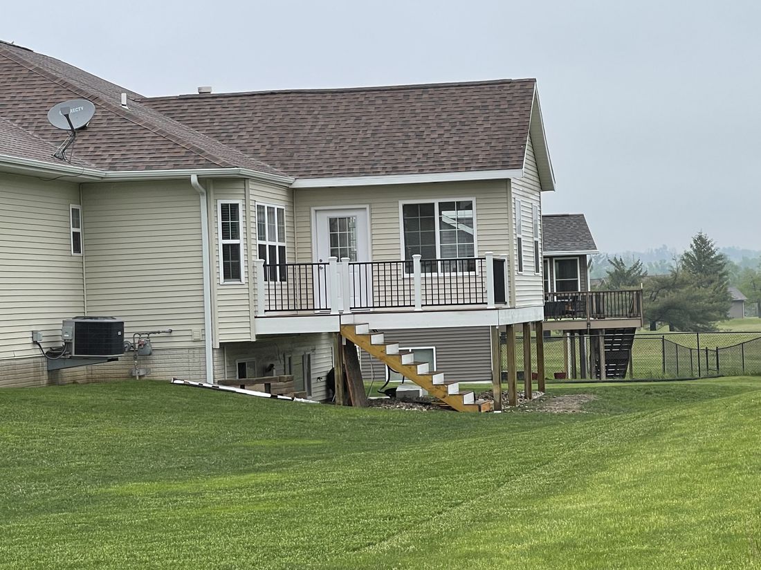 Completed roof, rear view of a home with a deck