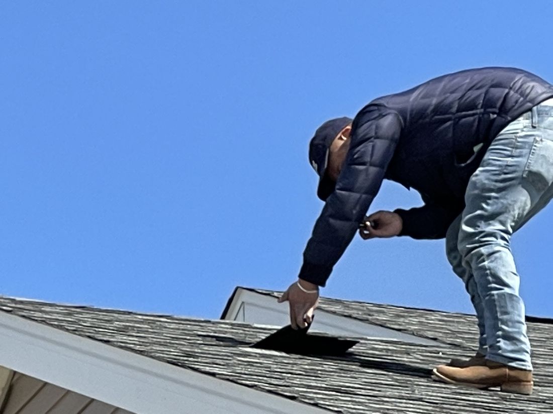 Completed roof on a ranch-style home with an attached garage