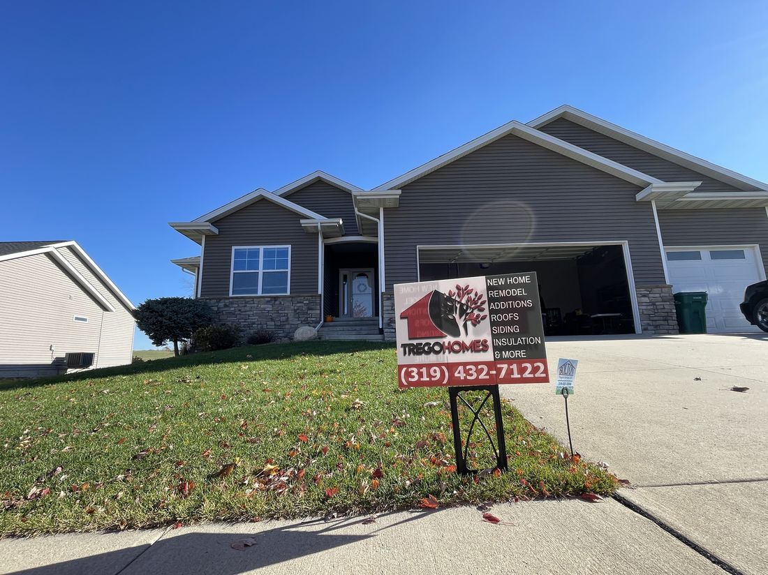 Completed roof on a ranch-style home with a Trego Homes yard sign out front