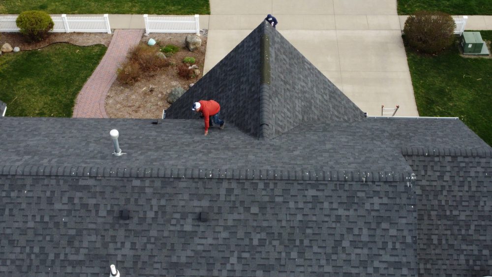 Trego Roofing crew member walking a completed roof installation