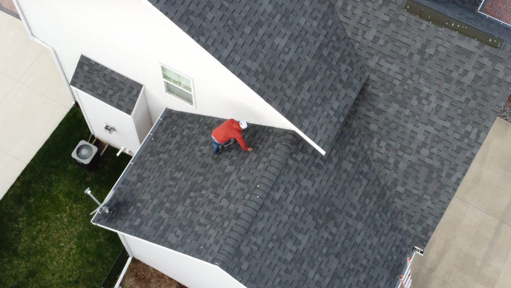 Trego Roofing crew member finishing a roof edge