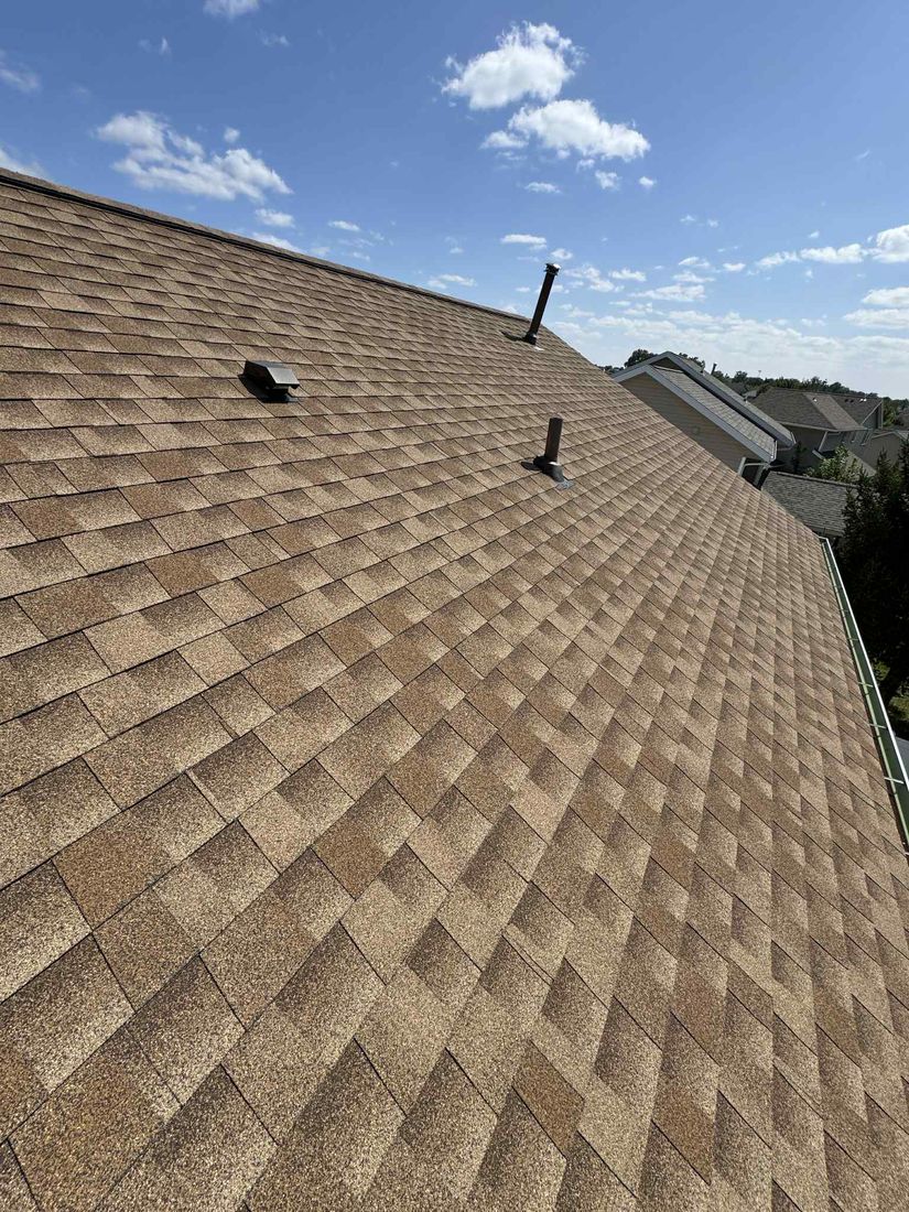 Close-up of asphalt shingles and roof vents after a repair by Trego Roofing