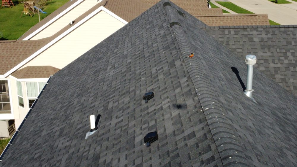Aerial detail of a roof valley and vent boots, Trego Roofing