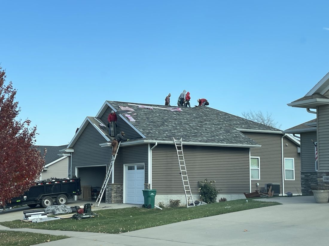 Trego Roofing crew repairing a roof after storm damage