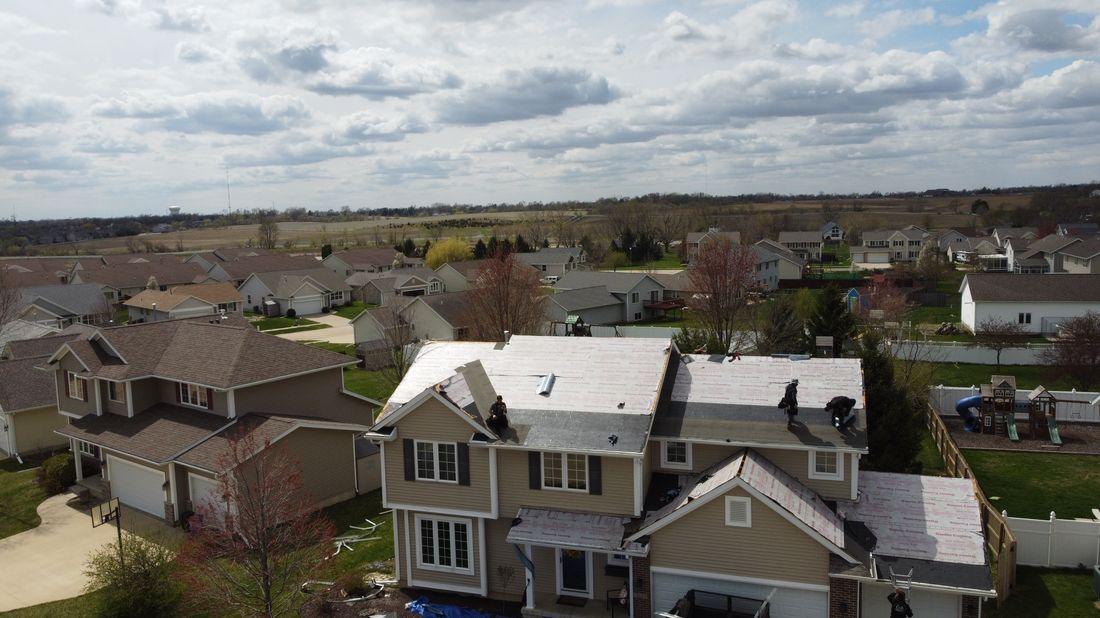 Aerial view of a Trego Roofing crew repairing a roof after storm damage