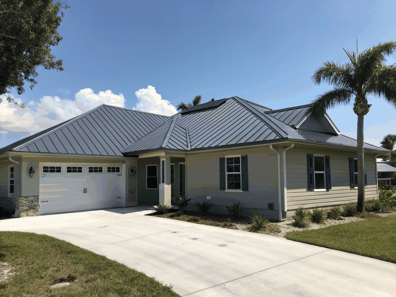 Dark standing seam metal roof installed on modern home